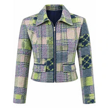 A cropped zip-up jacket featuring a multicolor plaid and geometric pattern in shades of green, purple, pink, and navy blue, displayed on a clean white background.