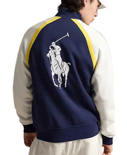A person shown from the back wearing a navy, white, and yellow Polo Ralph Lauren track jacket, featuring the signature polo player logo on the back.