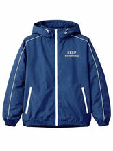 A navy blue hooded windbreaker jacket with white piping, a white front zipper, and 'KEEP SWIMMING' printed in white on the left chest, shown against a plain white background.