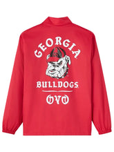 A red long-sleeve jacket with a high collar, featuring a large white and black graphic on the back with the text 'GEORGIA BULLDOGS' and the Bulldogs mascot illustration.
