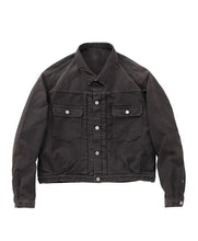 A black cotton twill utility jacket with silver snap buttons and flap chest pockets, displayed flat against a solid white background.