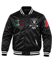 A black satin bomber jacket featuring the Raiders logo on the left chest, 'Viva los Raiders' embroidered on the right chest, and a red 'A' patch on the sleeve, shown against a plain white background.
