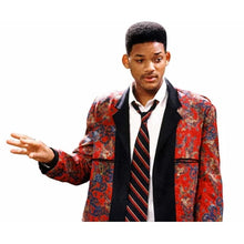 A man wearing a red patterned blazer with black lapels, a white dress shirt, and a red and black striped tie, posed against a plain white background.