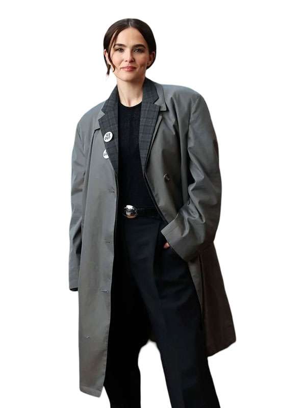 A woman modeling a long gray double-breasted coat over a black outfit, photographed against a plain white background.