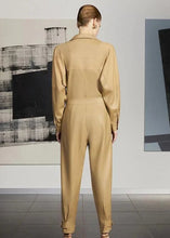 Front view of women’s light brown leather jumpsuit