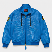 A bright blue bomber jacket with a rib cage graphic on the front, gold zipper, and embroidered yellow star patches on the sleeves, shown flat on a light gray background.